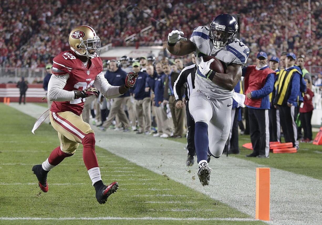 Seattle Seahawks running back Robert Turbin (22) scores on a 13-yard touchdown reception in front of San Francisco 49ers defensive back Chris Culliver (29) during the first quarter in Santa Clara, Calif., on Thursday.