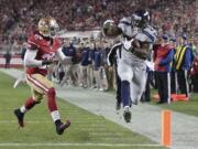 Seattle Seahawks running back Robert Turbin (22) scores on a 13-yard touchdown reception in front of San Francisco 49ers defensive back Chris Culliver (29) during the first quarter in Santa Clara, Calif., on Thursday.