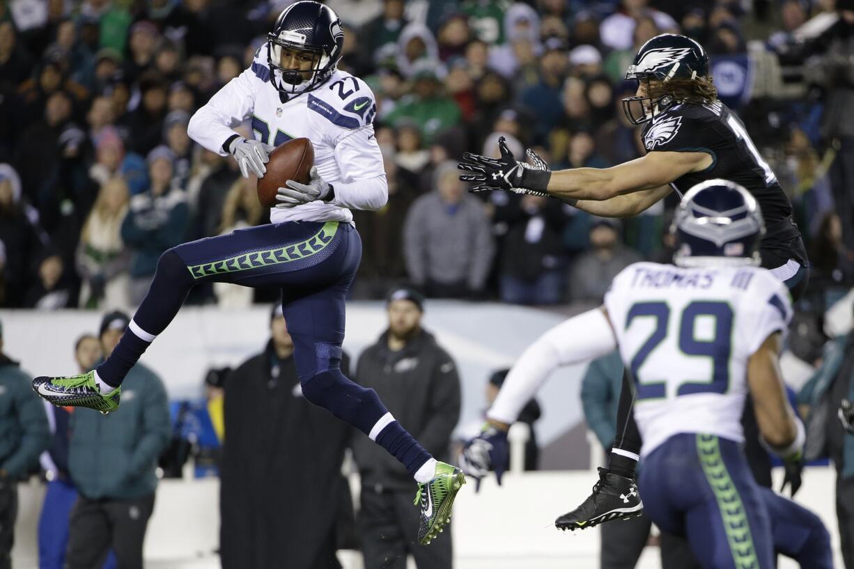 Seattle Seahawks' Tharold Simon (27) intercepts a pass intended for Philadelphia Eagles' Riley Cooper (14) during the second half Sunday.