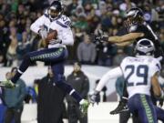 Seattle Seahawks' Tharold Simon (27) intercepts a pass intended for Philadelphia Eagles' Riley Cooper (14) during the second half Sunday.