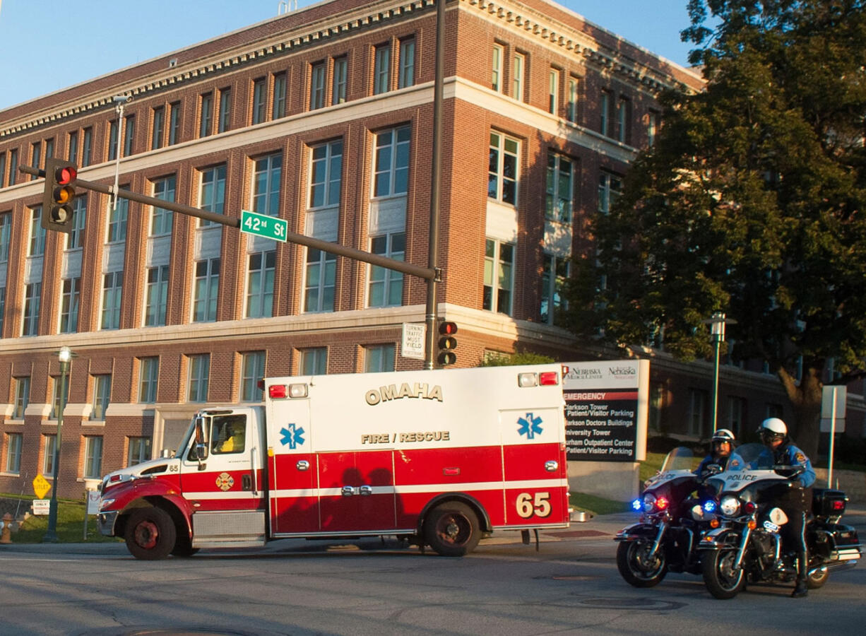 An ambulance transports Ashoka Mukpo, who contracted Ebola while working in Liberia, to the Nebraska Medical Center's specialized isolation unit Monday in Omaha, Neb., where he will be treated for the deadly disease.