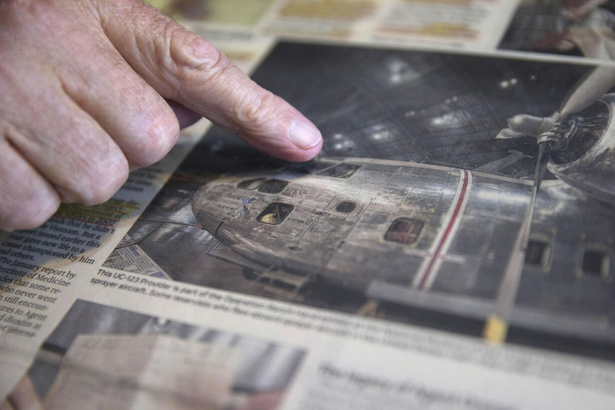 Retired Air Force reserve tech Sgt. Ed Kienle, 73, points to a news article depicting a Fairchild C-123 aircraft during an interview at his home June 11 in Wilmington, Ohio. The government says U.S. Air Force reservists who became ill after being exposed to Agent Orange residue while working on planes after the Vietnam War would be eligible for disability benefits. The Department of Veterans Affairs said it has been working to finalize a rule that could cover more than 2,000 military personnel, including Kienle, who flew or worked on Fairchild C-123 aircraft in the U.S.