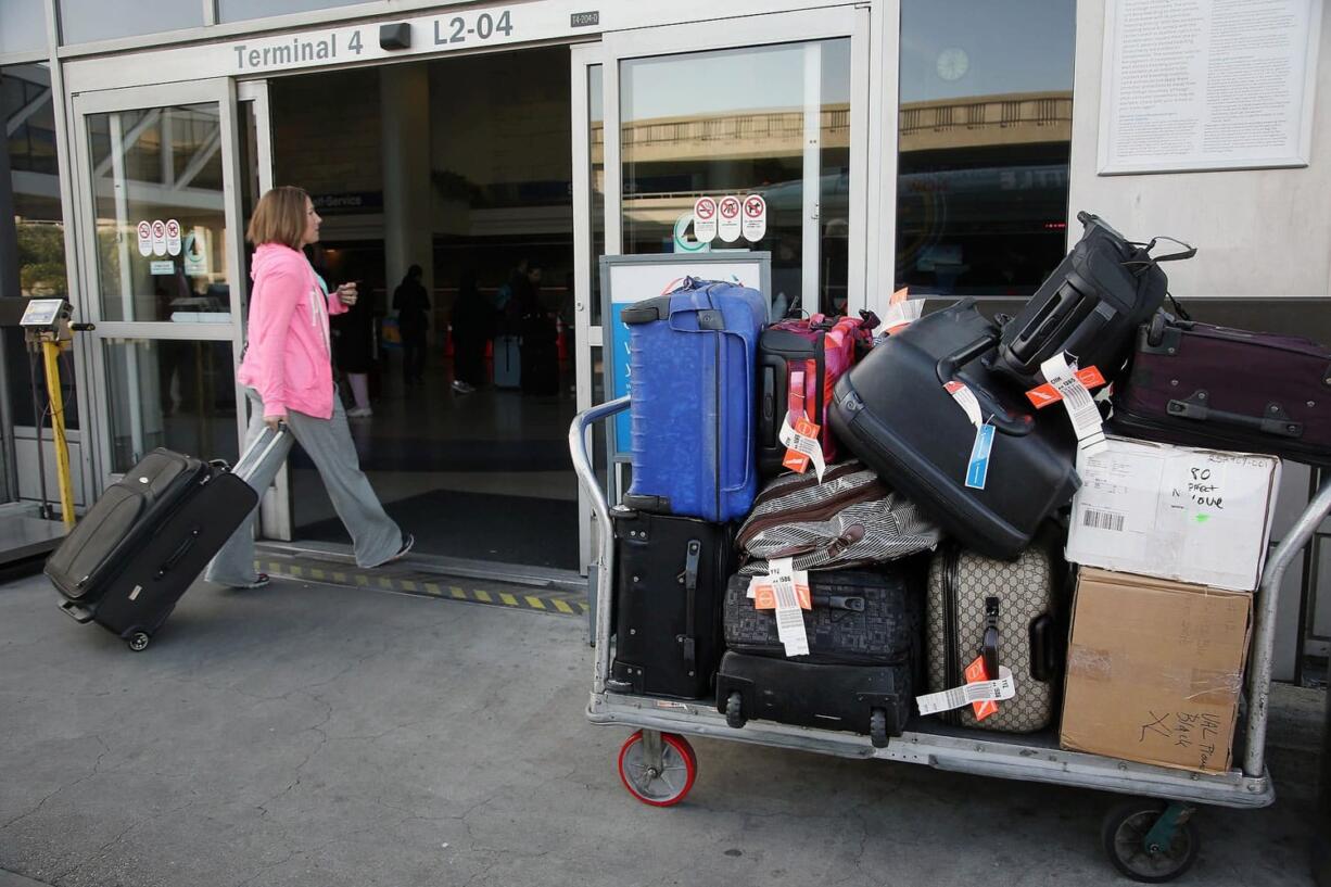 A baggage cart sits outside a terminal at Los Angeles International Airport in Los Angeles.