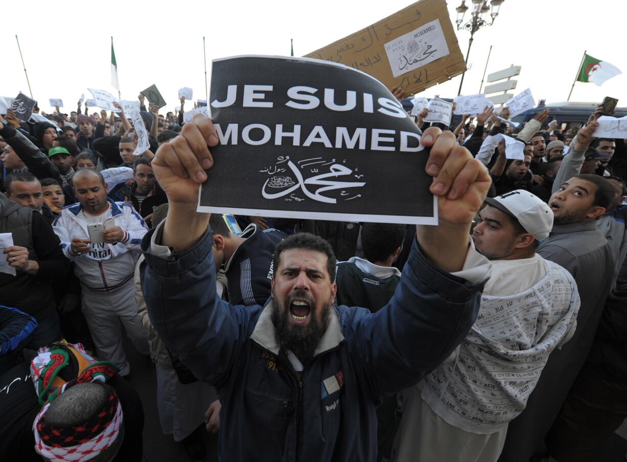 A demonstrator holds up a &quot;Je suis Mohamed&quot; (&quot;I am Mohamed&quot;) sign during a protest Friday in Algiers, Algeria, denouncing cartoons of the Prophet Muhammad published by French satirical weekly Charlie Hebdo.