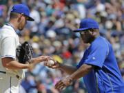 Seattle Mariners pitcher David Rollins, left, is pulled by manager Lloyd McClendon, right, in the sixth inning against the Los Angeles Angels, Sunday, July 12, 2015, in Seattle. (AP Photo/Ted S.