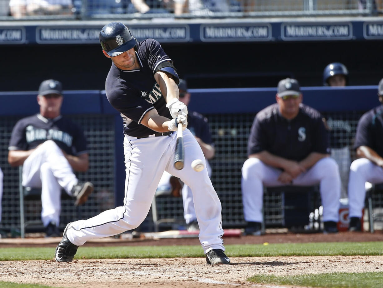 Seattle Mariners' Mike Zunino rips a two run double against the Los Angeles Angels in the fourth inning of a spring training baseball game Monday, March 30, 2015, in Peoria, Ariz.