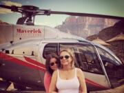 Brittany Maynard, left, hugs her mother Debbie Ziegler next to a helicopter at the Grand Canyon National Park in Arizona on Oct.