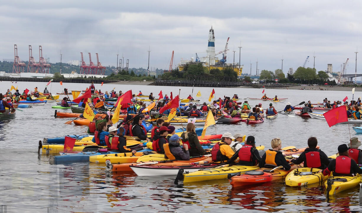 Activists in kayaks who oppose Royal Dutch Shell's plans to drill for oil in the Arctic Ocean, prepare to paddle to Shell's Polar Pioneer drilling rig docked in Elliott Bay, during the &quot;Paddle in Seattle&quot; protest on Saturday in Seattle.