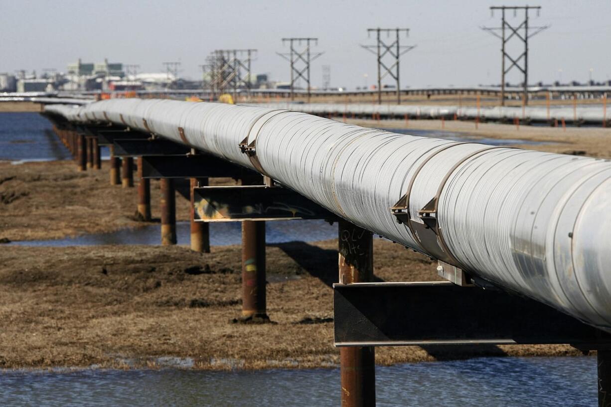 In this 2007 photo, an oil transit pipeline runs across the tundra to flow station at the Prudhoe Bay oil field on Alaska's North Slope.