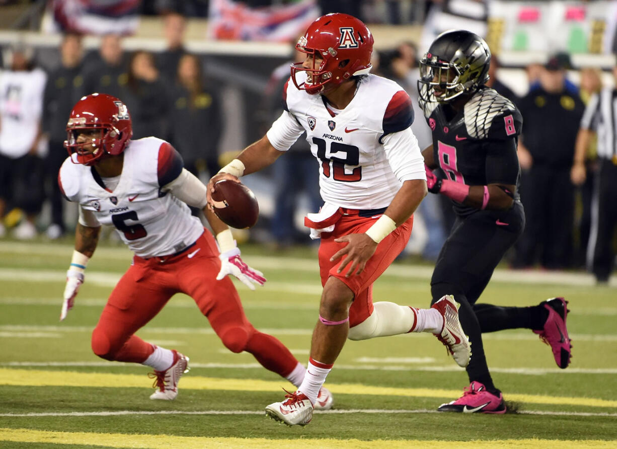 Arizona quarterback Anu Solomon (12) runs with the ball during the second quarter against Oregon on Thursday, Oct. 2, 2014, in Eugene, Ore.