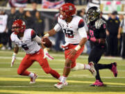 Arizona quarterback Anu Solomon (12) runs with the ball during the second quarter against Oregon on Thursday, Oct. 2, 2014, in Eugene, Ore.