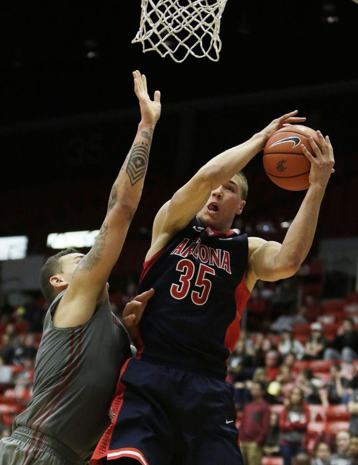 Arizona's Kaleb Tarczewski (35) grabs a rebound against Washington State's Jordan Railey during the second half Sunday, Feb. 15, 2015, in Pullman. Arizona won 86-59.