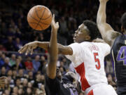 Arizona's Stanley Johnson (5) tries to knock the ball away as Washington's Donaven Dorsey drives during the first half Friday, Feb.