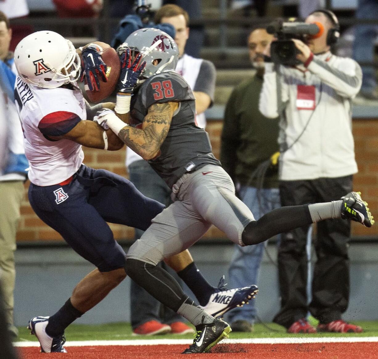 Arizona wide receiver Trey Griffey (5) catches touchdown pass while defended by Washington State cornerback Kevin Griffin (38) during the third quarter Saturday, Oct. 25, 2014, at Martin Stadium in Pullman, Wash. Arizona won 59-37.