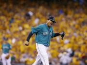 With a sea of yellow from his &quot;King's Court&quot; cheering section behind him, Seattle Mariners starting pitcher Felix Hernandez yells after a double play in the eighth inning of a baseball game against the Oakland Athletics, Friday, July 11, 2014, in Seattle. (AP Photo/Ted S.