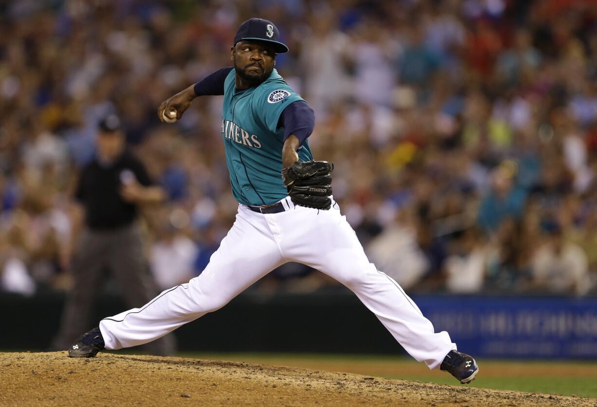 Seattle Mariners closer Fernando Rodney throws in the ninth inning of a baseball game against the Oakland Athletics, Friday, July 11, 2014, in Seattle. The Mariners won 3-2. (AP Photo/Ted S.