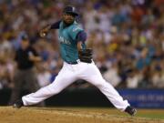 Seattle Mariners closer Fernando Rodney throws in the ninth inning of a baseball game against the Oakland Athletics, Friday, July 11, 2014, in Seattle. The Mariners won 3-2. (AP Photo/Ted S.