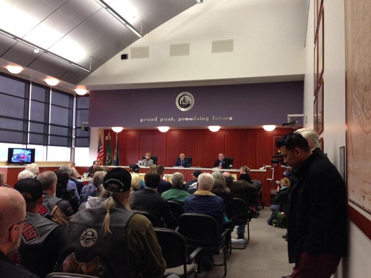 A crowd packed the county council hearings room this morning to talk about adding the words &quot;In God We Trust&quot; to the wall above the dais.