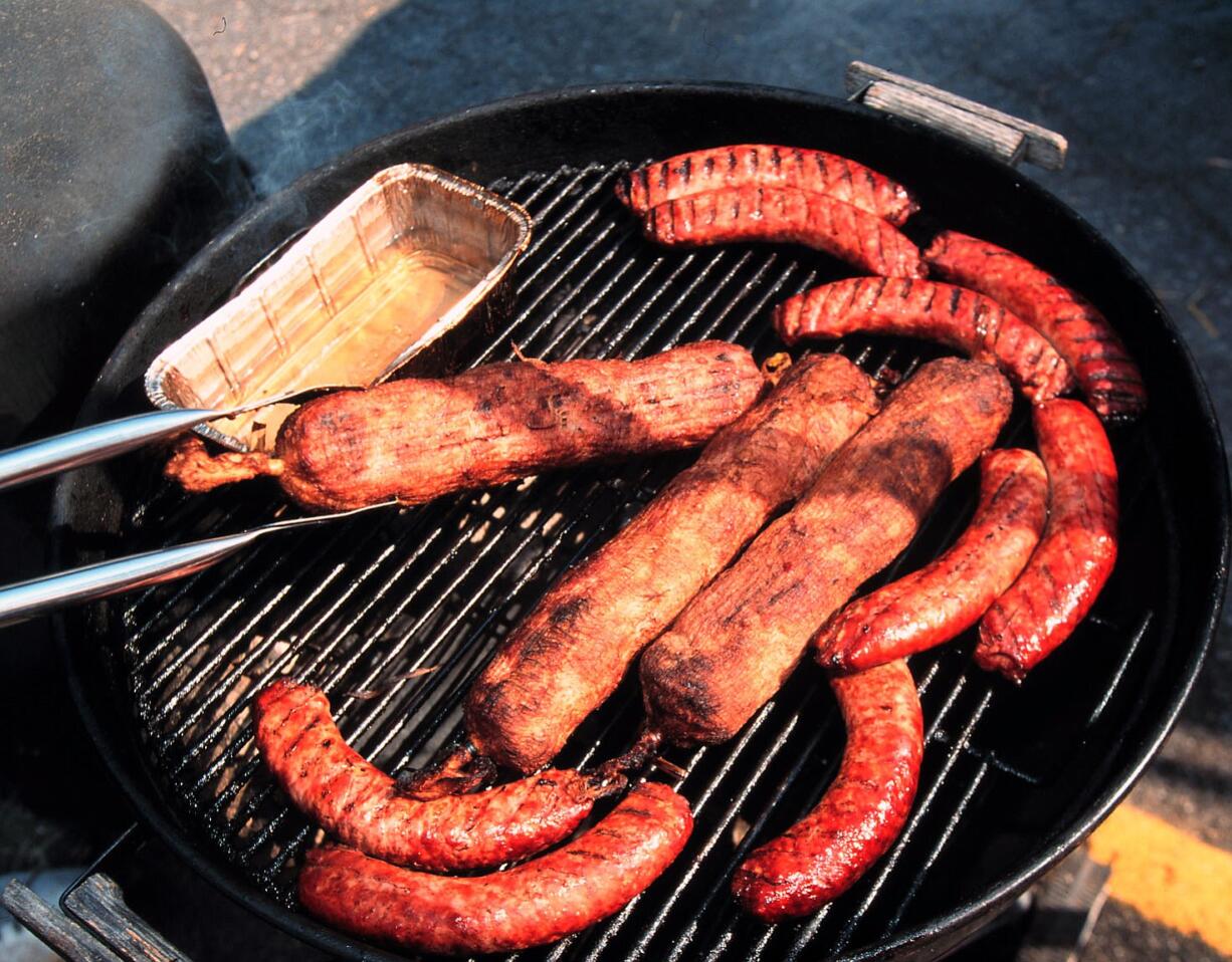 Sausages cooking on a kettle smoker at the American Royal.