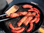 Sausages cooking on a kettle smoker at the American Royal.