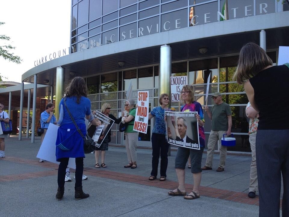 People gather outside the Public Service Center in downtown Vancouver before the Clark County Commissioners meeting on Tuesday.