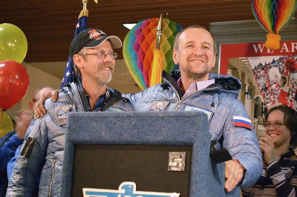 Troy Bradley of Albuquerque, N.M., left, and Leonid Tiukhtyaev of Russia, speak to reporters and supporters Sunday at Albuquerque International Sunport a day after beating what's considered the &quot;holy grail&quot; of ballooning achievements.