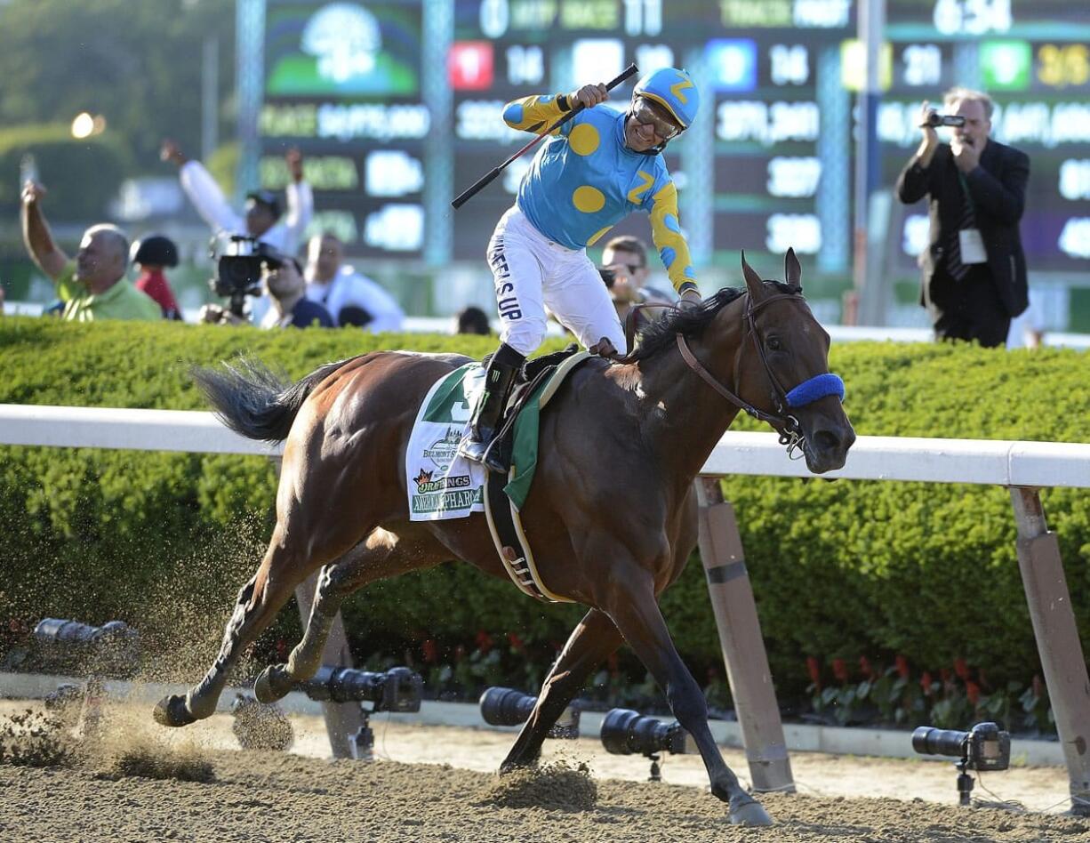 Victor Espinoza reacts after crossing the finish line with American Pharoah (5) to win the 147th running of the Belmont Stakes horse race at Belmont Park, Saturday, June 6, 2015, in Elmont, N.Y. American Pharoah is the first horse to win the Triple Crown since Affirmed won it in 1978.