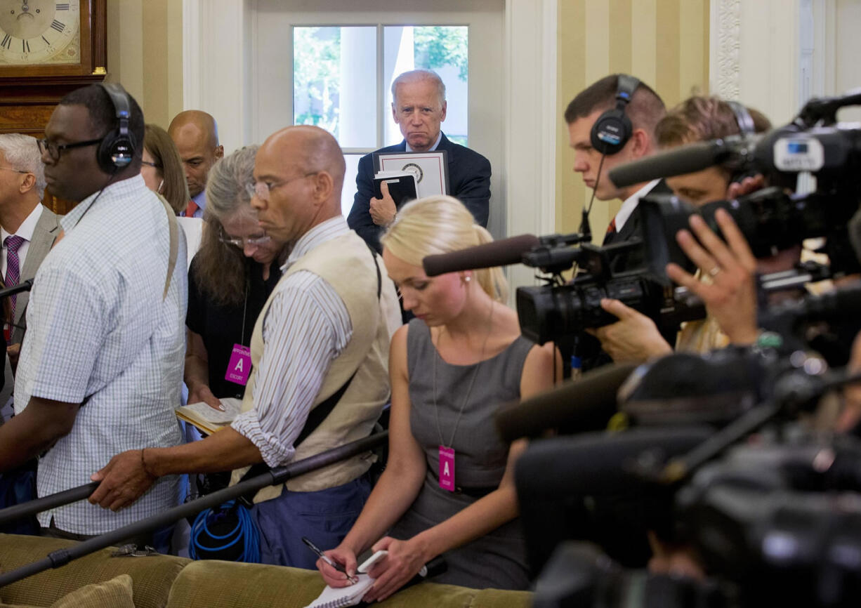 Associated Press files
Vice President Joe Biden, at rear, listens to remarks to the media during a meeting May 26 between President Barack Obama and NATO Secretary General Jens Stoltenberg in the Oval Office of the White House.