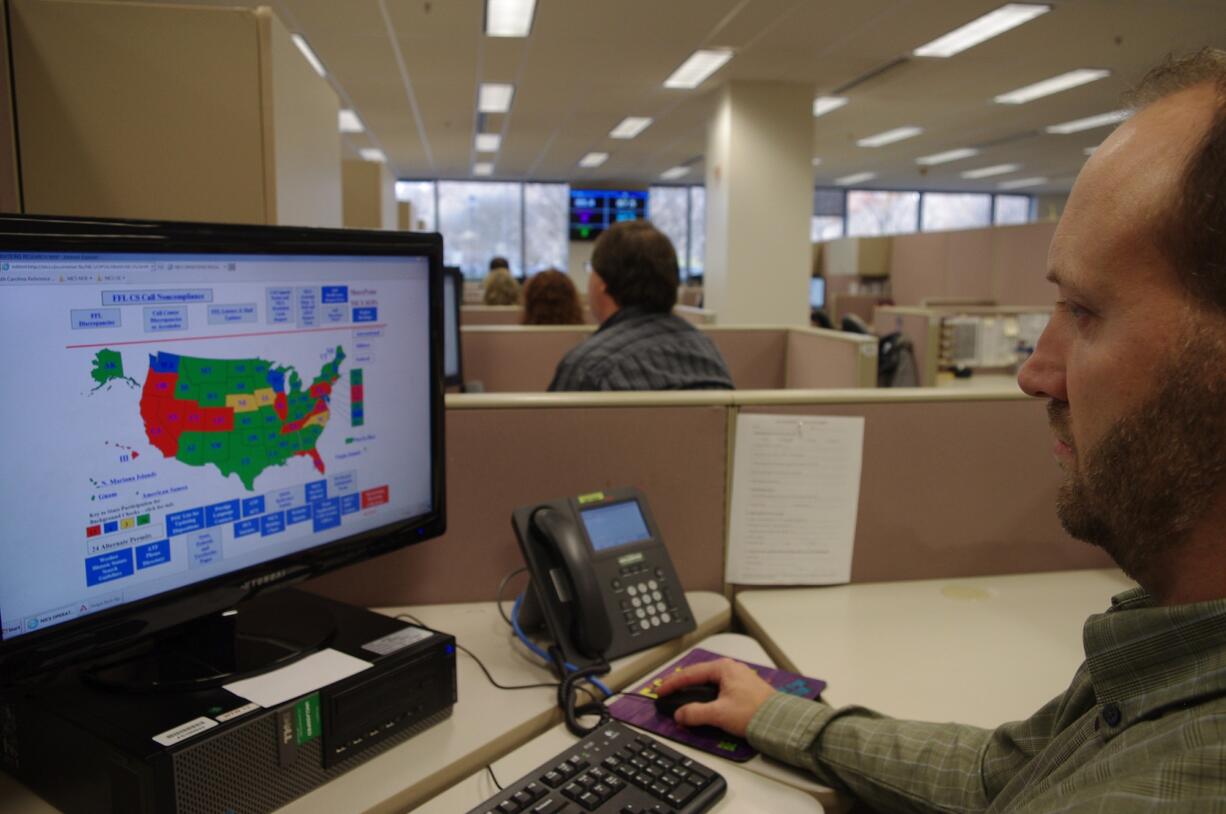 A researcher simulates a check done for the National Instant Criminal Background Check System or NICS, at the FBI's criminal justice center in Bridgeport, W.Va.