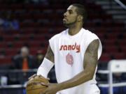 Portland Trail Blazers forward LaMarcus Aldridge wears a warmup shirt in memory of season ticket holder Sandra Zickefoose before their NBA basketball game against the Denver Nuggets in Portland, Ore., Sunday, Nov. 9, 2014. Zickefoose suffered a medical emergency during their game against Dallas Thursday night, was transported to a hospital and subsequently died.