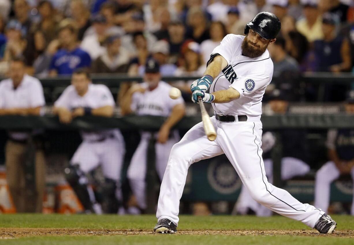 Seattle Mariners Dustin Ackley hits a two-run single in the fifth inning of a baseball game against the Toronto Blue Jays, Tuesday, Aug. 12, 2014, in Seattle. (AP Photo/Ted S.