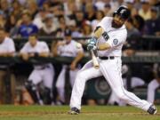 Seattle Mariners Dustin Ackley hits a two-run single in the fifth inning of a baseball game against the Toronto Blue Jays, Tuesday, Aug. 12, 2014, in Seattle. (AP Photo/Ted S.