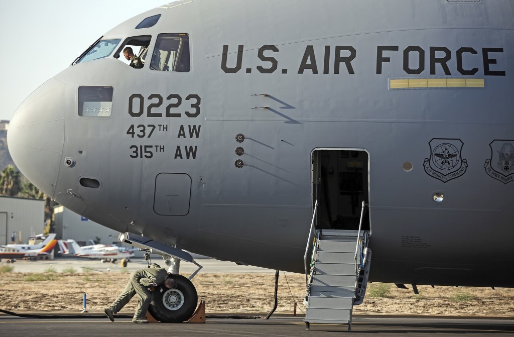 Members of the U.S. Air Force's 437th Airlift Wing perform a pre-flight check as Boeing Co. hands them out the last C-17 Globemaster III cargo jet for the U.S.