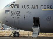 Members of the U.S. Air Force's 437th Airlift Wing perform a pre-flight check as Boeing Co. hands them out the last C-17 Globemaster III cargo jet for the U.S.