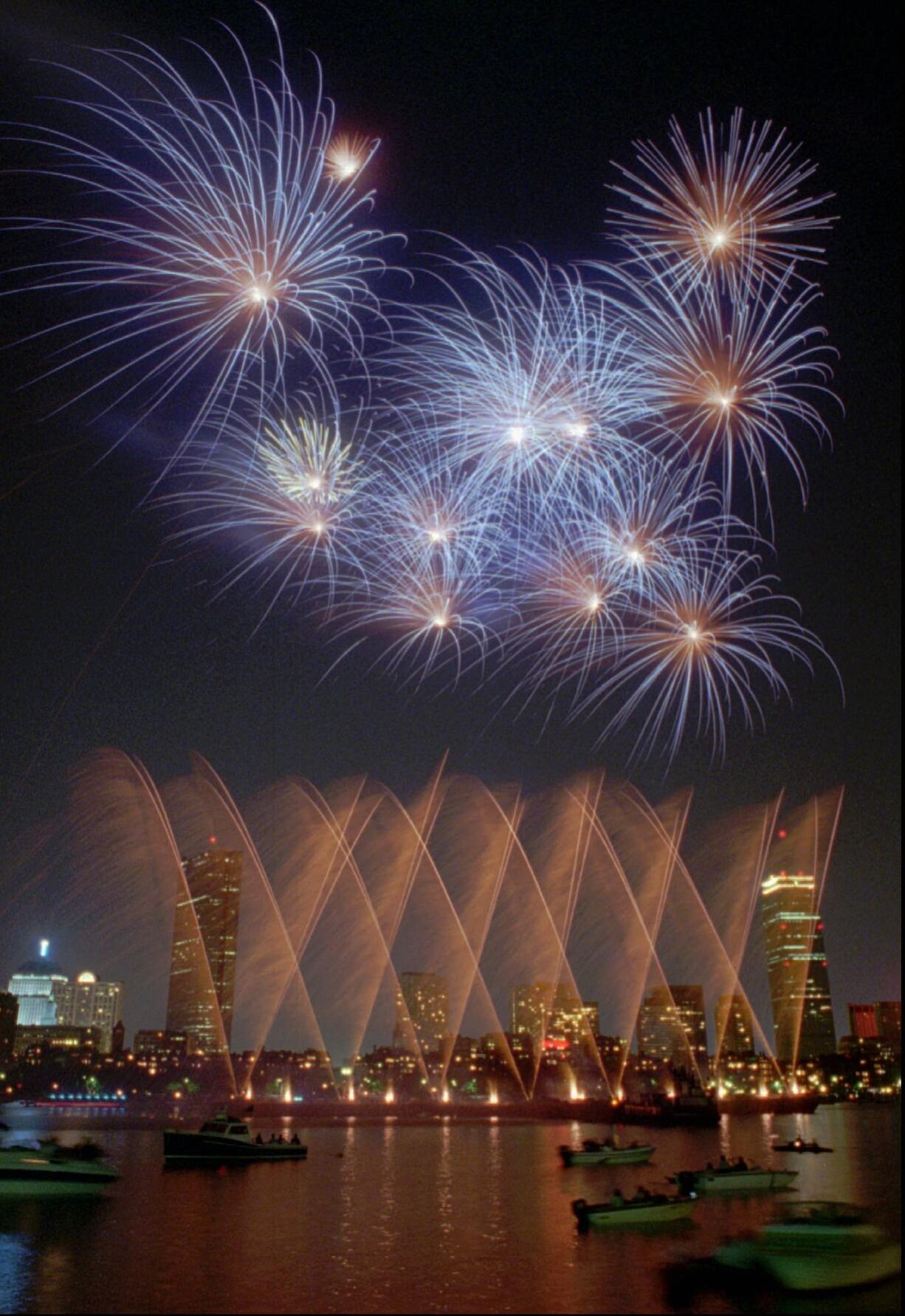 Fireworks illuminate the Charles River after the Boston Pops concert at the Hatch Shell as part of the Fourth of July celebrations in Boston in 1995.