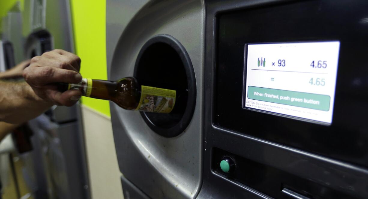 A bottle is turned in at a Bottledrop Oregon Redemption Center in Gresham, Ore., Friday, July 31, 2015.