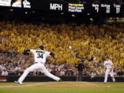 A sea of yellow &quot;K&quot; cards, designating a strikeout, are held in the stands behind Seattle Mariners staring pitcher Felix Hernandez as he throws against the Atlanta Braves in the eighth inning of a baseball game Tuesday, Aug. 5, 2014, in Seattle.