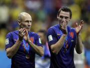 Netherlands' Arjen Robben, left and Stefan de Vrij applaud their supporters after their 3-0 victory over Brazil in the World Cup third-place match Saturday.