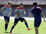 United Statesu2019 Clint Dempsey, center, and Matt Besler, left, work out during a training session in Salvador, Brazil, Monday.