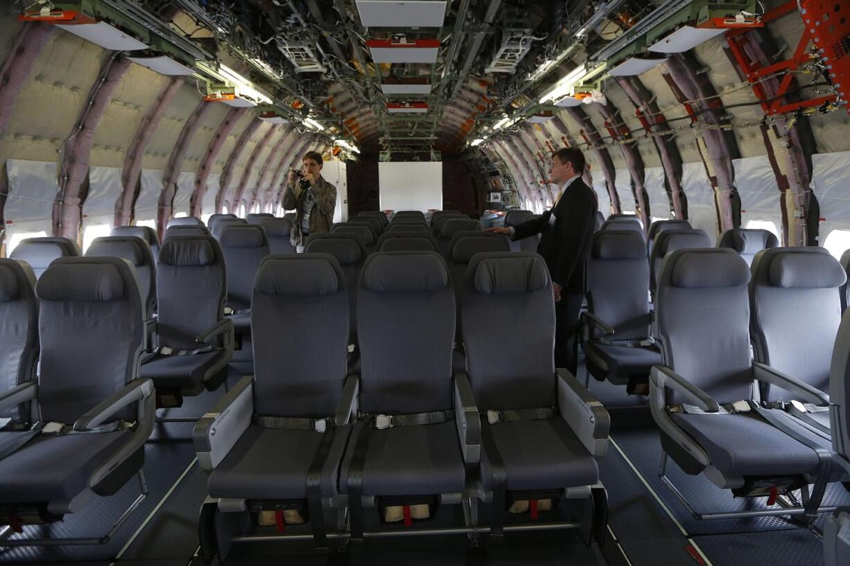 A visitor takes a picture inside an unfitted Airbus A350 XWB as it stands on display Monday during the Farnborough International Air Show, Farnborough, England.