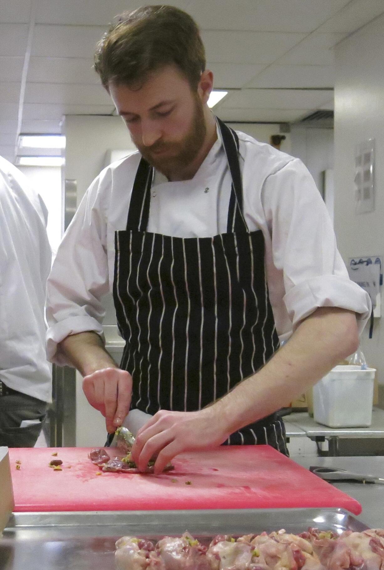 Chef Dave Colgan prepares stuffed quails Thursday for a &quot;Game of Thrones&quot;-themed banquet at Andaz Hotel in London.