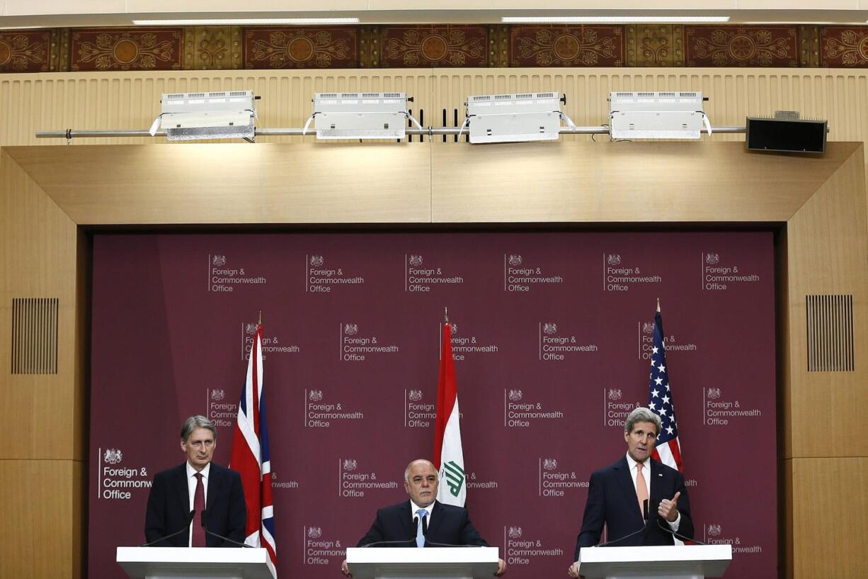 From left to right Britain's Foreign Secretary Philip Hammond, Iraq's Prime Minister Haider al-Abadi and U.S.