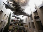 Military exhibits are displayed in the newly transformed atrium after major redevelopment works at the Imperial War Museum in London, Wednesday, July 16, 2014.  The museum reopens Saturday after a six-month closure for a 40 million pound ($70 million) renovation timed to mark the centenary of World War I.  The museum was founded in 1917, as the war still raged, to preserve the stories of those who were fighting and dying. It retains that goal, as well its archaic name, relic of a long-gone British Empire.