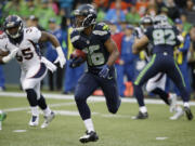 Seattle Seahawks' Tyler Lockett returns a kickoff 103 yards for a touchdown against the Denver Broncos during the second quarter of a preseason NFL football game, Friday, Aug.