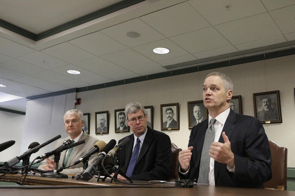 Rep. Ross Hunter, from right, talks to the media about the latest budget proposal as House Majority Leader Pat Sullivan and Rep. Reuven Carlyle listen Monday in Olympia.