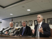 Rep. Ross Hunter, from right, talks to the media about the latest budget proposal as House Majority Leader Pat Sullivan and Rep. Reuven Carlyle listen Monday in Olympia.