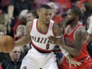 Chicago Bulls guard Aaron Brooks, right, defends Portland Trail Blazers guard Damian Lillard during the first half Friday, Nov. 21, 2014.