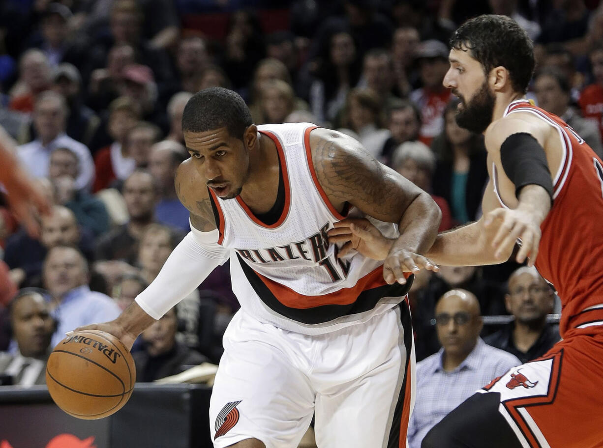 Portland Trail Blazers forward LaMarcus Aldridge, left, drives on Chicago Bulls forward Nikola Mirotic during the second half of an NBA basketball game  in Portland, Ore., Friday, Nov. 21, 2014.  Aldridge scored 16 points as the Trail Blazers defeated the Bulls 105-87.