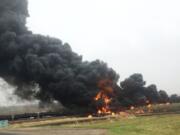 Smoke and fire billow from an oil train that derailed Wednesday in Heimdal, N.D. Ten tanker cars on the BNSF caught fire, prompting the evacuation of Heimdal, where about three dozen people live. No injuries were reported. BNSF Railway is planning to reopen the track Friday.