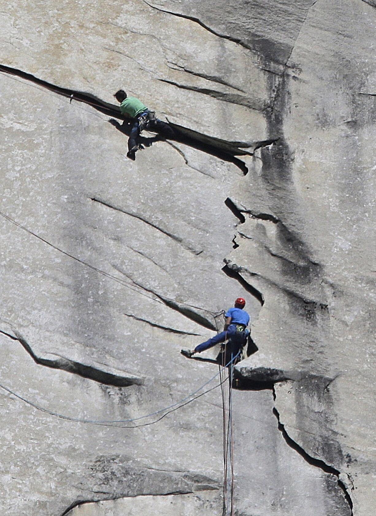 Photos by BEN MARGOT/Associated Press
Kevin Jorgeson, wearing green, and Tommy Caldwell, wearing blue, near the summit of El Capitan on Wednesday in Yosemite National Park, Calif.